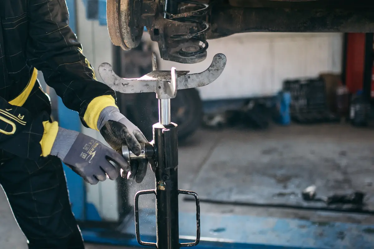 Professional auto repair shop with a mechanic working on a vehicle in a clean bay