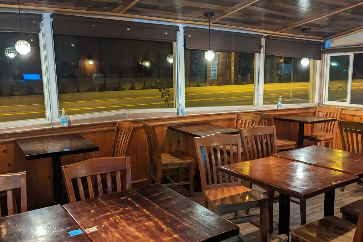 Elegant restaurant interior with warm lighting, set tables, and inviting dining atmosphere